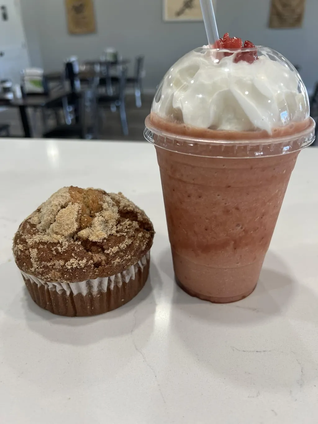 Strawberry frappé with whipped cream beside a fresh muffin at Java Don's, Afton OK